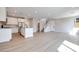 Bright, open-concept living space features hardwood floors, a modern kitchen, and a staircase at 3357 Via Tizzoni St, Henderson, NV 89044