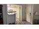 Compact kitchen featuring white cabinetry, appliances, and eating bar adjacent to entryway at 3550 Bay Sands Dr # 3051, Laughlin, NV 89029