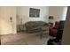 Comfortable living room with olive sofa, recliner chair, side table, and muted tones throughout at 3550 Bay Sands Dr # 3051, Laughlin, NV 89029
