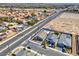 Aerial view of a home with a kidney-shaped pool, new landscaping, and convenient street access at 3556 Valley Lily St, North Las Vegas, NV 89032