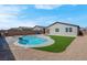 The backyard features a modern swimming pool and artificial turf with a brick perimeter fence at 3556 Valley Lily St, North Las Vegas, NV 89032