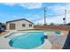 The backyard features a modern swimming pool and artificial turf with a brick perimeter fence at 3556 Valley Lily St, North Las Vegas, NV 89032