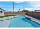 The backyard features a modern swimming pool and artificial turf with a brick perimeter fence at 3556 Valley Lily St, North Las Vegas, NV 89032