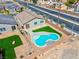Aerial view of a home with a kidney-shaped pool, new landscaping, and fenced yard at 3556 Valley Lily St, North Las Vegas, NV 89032