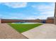 The backyard features a modern swimming pool and artificial turf with a brick perimeter fence at 3556 Valley Lily St, North Las Vegas, NV 89032