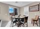 Cozy dining area with seating for four, a sliding glass door, and stylish decor at 3556 Valley Lily St, North Las Vegas, NV 89032