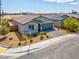 Charming single-story home with desert landscaping and a two-car garage on a sunny day at 3556 Valley Lily St, North Las Vegas, NV 89032