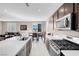 Bright kitchen featuring an island with bar seating, stainless steel appliances, and an adjoining dining area at 3556 Valley Lily St, North Las Vegas, NV 89032