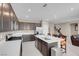 Modern kitchen boasts stainless steel appliances, white countertops, and ample dark wood cabinets for storage at 3556 Valley Lily St, North Las Vegas, NV 89032