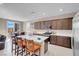 Kitchen with stainless steel appliances, white countertops, dark cabinetry, and breakfast nook near sliding door at 3556 Valley Lily St, North Las Vegas, NV 89032