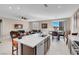 Kitchen with white countertops, stainless steel appliances, dark cabinets, and bar seating facing the living area at 3556 Valley Lily St, North Las Vegas, NV 89032