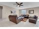Comfortable living room with a ceiling fan and ample seating, perfect for entertaining guests at 3556 Valley Lily St, North Las Vegas, NV 89032