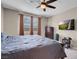 Comfortable main bedroom features neutral walls, ceiling fan, and large window at 3556 Valley Lily St, North Las Vegas, NV 89032
