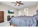 Spacious main bedroom featuring a ceiling fan, TV, and comfortable furnishings at 3556 Valley Lily St, North Las Vegas, NV 89032