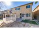 View of the backyard showing a covered gazebo, and back of house with multiple windows at 3774 Dusky Flycatcher St, Las Vegas, NV 89122