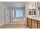 Bright bathroom featuring a glass enclosed shower, garden tub and a double sink vanity at 3774 Dusky Flycatcher St, Las Vegas, NV 89122