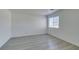 Bright bedroom with sleek gray wood-look floors and a large window offering plenty of natural light at 3774 Dusky Flycatcher St, Las Vegas, NV 89122