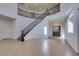 Spacious foyer with high ceilings, tile flooring and a grand staircase featuring wrought iron railings at 3774 Dusky Flycatcher St, Las Vegas, NV 89122