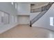 Grand foyer featuring a beautiful curved staircase and tile flooring at 3774 Dusky Flycatcher St, Las Vegas, NV 89122
