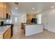 Open kitchen with island and granite countertops and oak cabinets at 3774 Dusky Flycatcher St, Las Vegas, NV 89122