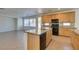 Open kitchen with a central island, tile floors, and modern black appliances, perfect for entertaining at 3774 Dusky Flycatcher St, Las Vegas, NV 89122