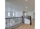 Upstairs landing with wrought iron railing, and wood look flooring at 3774 Dusky Flycatcher St, Las Vegas, NV 89122