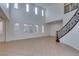 Bright living room with high ceilings and staircase with ornamental handrail at 3774 Dusky Flycatcher St, Las Vegas, NV 89122