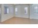 Bright living room showcasing neutral walls, tile flooring, and large windows providing ample natural light at 3774 Dusky Flycatcher St, Las Vegas, NV 89122