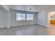Open living room with tile floors and large windows offering natural light with attached bathroom at 3774 Dusky Flycatcher St, Las Vegas, NV 89122