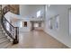 Spacious living room with soaring ceilings, elegant staircase, and natural light at 3774 Dusky Flycatcher St, Las Vegas, NV 89122