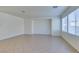 Bright and spacious living area featuring tile floors, recessed lighting, and large windows for natural light at 3774 Dusky Flycatcher St, Las Vegas, NV 89122