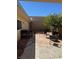 Private backyard featuring patio, dining set, and desert landscaping; ideal for outdoor entertaining at 3831 Atlantis St, Las Vegas, NV 89121