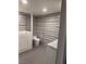 Bathroom features a walk-in tub and marble tile walls, accented by modern fixtures at 3831 Atlantis St, Las Vegas, NV 89121