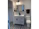 Bathroom featuring a white vanity, black hardware, and a toilet, creating a modern aesthetic at 3831 Atlantis St, Las Vegas, NV 89121