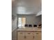 Kitchen island with white cabinets, granite counters, and view of the backyard at 3831 Atlantis St, Las Vegas, NV 89121