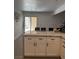 Kitchen island with white cabinets, granite counters, and view of the backyard at 3831 Atlantis St, Las Vegas, NV 89121