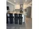Modern kitchen with white cabinets, stainless steel appliances, granite countertops, and eat-in breakfast bar at 3831 Atlantis St, Las Vegas, NV 89121