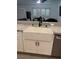 Farmhouse sink with black faucet, granite counters and white cabinets at 3831 Atlantis St, Las Vegas, NV 89121