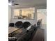Open-concept living room featuring contemporary furnishings, ceiling fan, and pass-through window to the kitchen at 3831 Atlantis St, Las Vegas, NV 89121