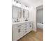 Bathroom with double sink vanity, granite countertop and black fixtures at 4450 San Rafael Ave, Las Vegas, NV 89120
