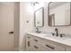 Modern bathroom featuring double vanity with framed mirrors, white cabinets and dark hardware at 4450 San Rafael Ave, Las Vegas, NV 89120