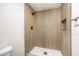 Close-up view of the new shower showcasing tile and black fixtures at 4450 San Rafael Ave, Las Vegas, NV 89120