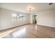 Bright living room featuring light-wood floors, contemporary lighting, and a large window at 4450 San Rafael Ave, Las Vegas, NV 89120
