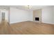 Bright living room with wood floors features a fireplace and decorative lighting at 4450 San Rafael Ave, Las Vegas, NV 89120