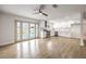 Open-concept living space with modern kitchen, light-wood floors and French doors leading to pool at 4450 San Rafael Ave, Las Vegas, NV 89120