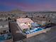 This aerial view showcases a backyard with a pool, spa, outdoor kitchen, and living area at 4505 Amazing View St, Las Vegas, NV 89129