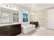 Relaxing bathroom with double vanities, soaking tub, and decorative art at 4505 Amazing View St, Las Vegas, NV 89129