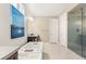 Bright bathroom featuring a modern tub, separate glass shower, and stylish fixtures at 4505 Amazing View St, Las Vegas, NV 89129