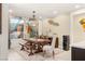 Elegant dining room featuring a large wooden table, stylish chandelier, and tasteful decor at 4505 Amazing View St, Las Vegas, NV 89129