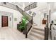 Bright entryway featuring a staircase, wood floors, and decorative accents at 4505 Amazing View St, Las Vegas, NV 89129